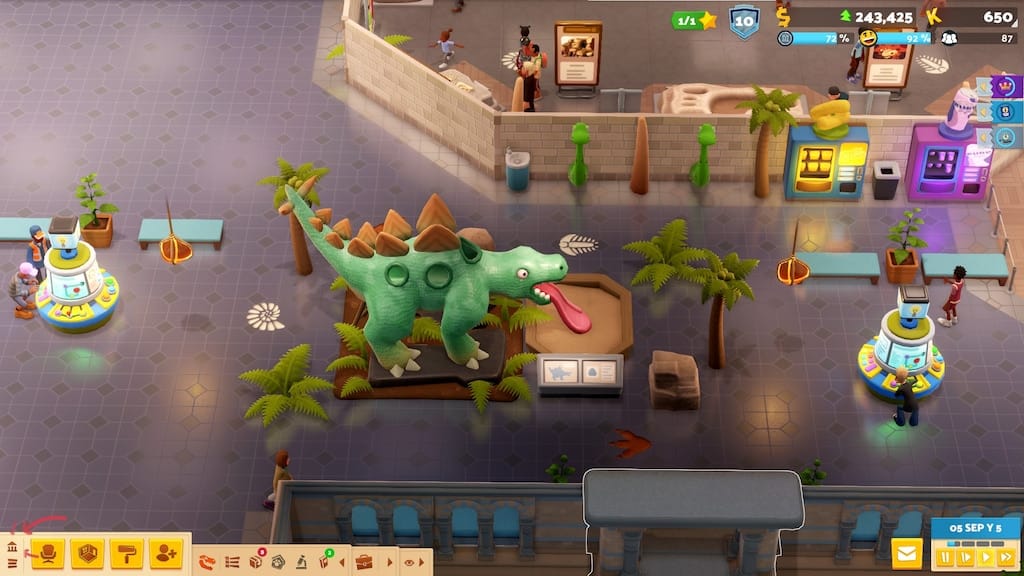 Tangkapan layar gameplay Two Point Museum yang menampilkan area pameran dinosaurus.